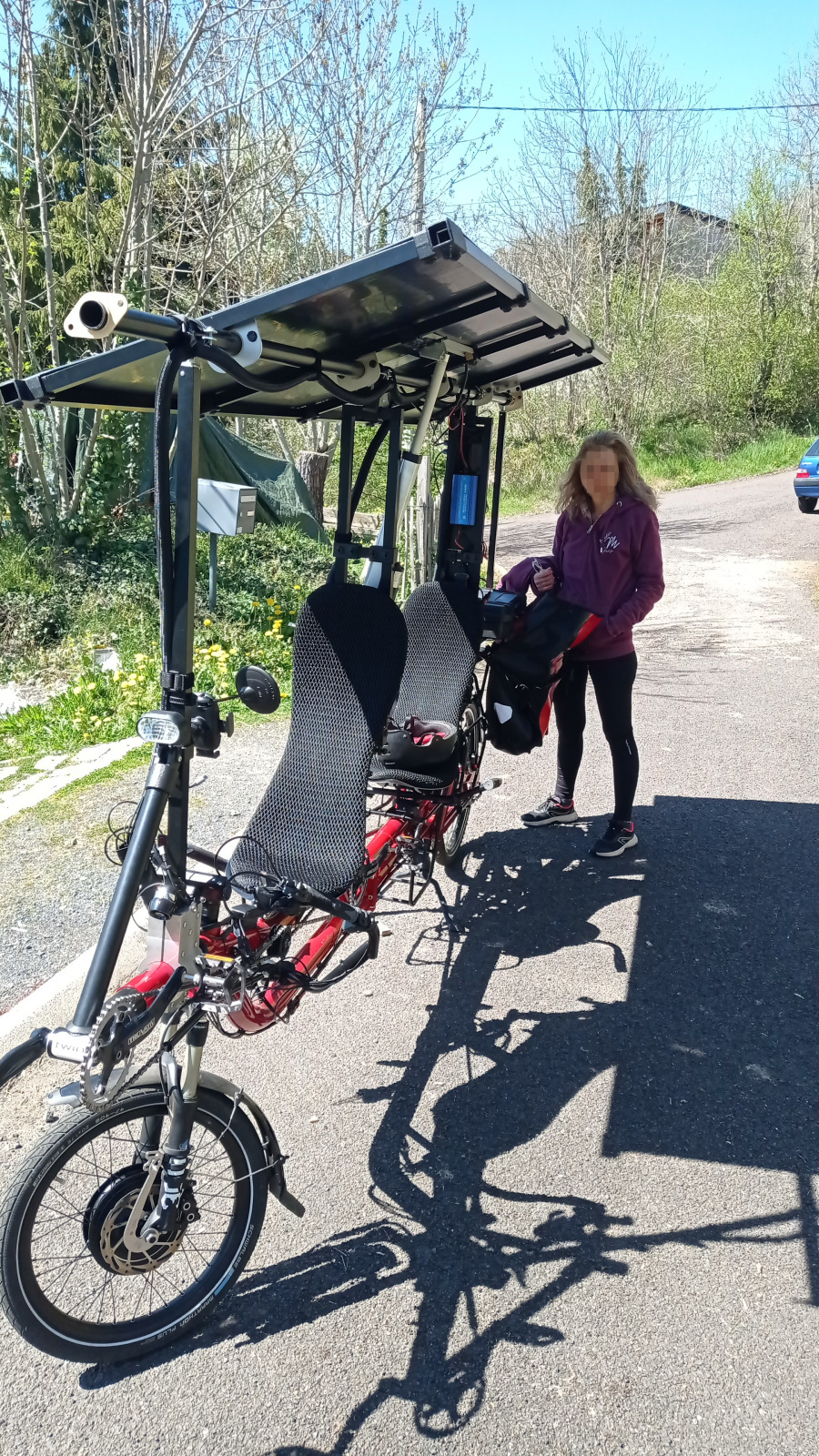 Recumbent tandem with dual motors and automatic tilting of solar panels