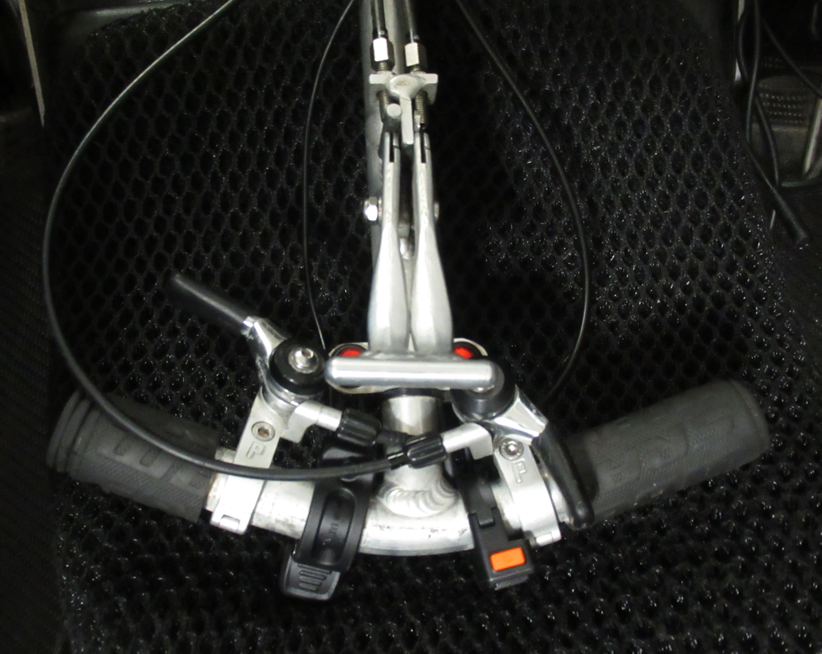The small control yoke was already crowded with center-mounted brake lever, turn signal indicator switches, shifters for the front and rear derailleurs, and the electric horn button. To these I managed to add the thumb throttle at left, and the multi-function level switch at right for the pedal assist system.