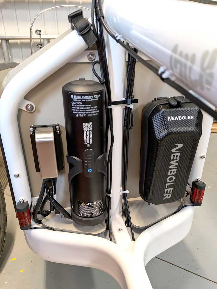 Phaserunner on the far left. As it's not in the wind I installed it on a pair of Grin heatsink frames. Then there's a 36v bottle battery that powers all of the accessories (lights, horn, etc.) That battery can also serve as a motor battery backup in an pinch.