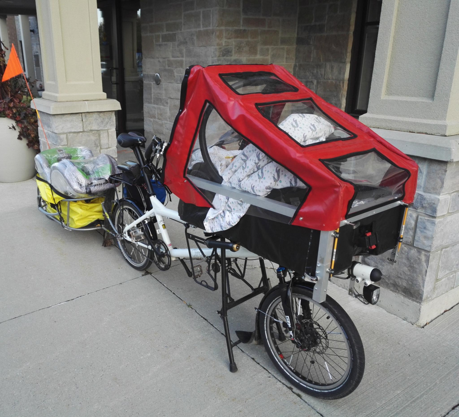 Here's the canopy configuration at 6-12 months old. Suspended baby car seat in the front, cargo trailer pulling the just acquired next car seat for the car. GMAC was added shortly after this - what a difference it made.