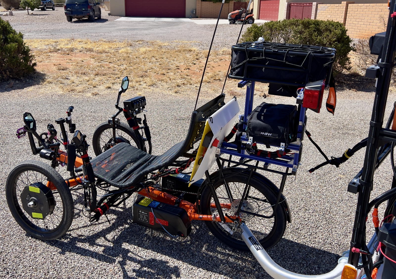 Two LGecolfp 48 vlot 20 amp hour lithium ion batteries power Amber Amp. Just running the trike I get about 125 to 145 mile range. Note the custom rack made from 2020 T-Slot extruded aluminum. T-Cycle mounts hold the batteries.