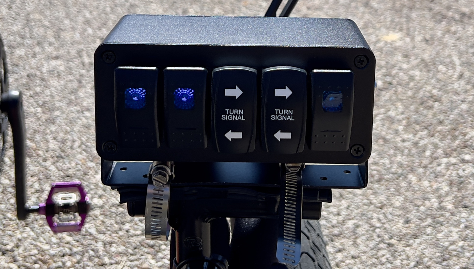 This custom rocker switch box controls Amber Amps flashers, running lights, and turn signals. The right two switches are powered from Cochise Caravan and control the turning signals and turn signal running lights.