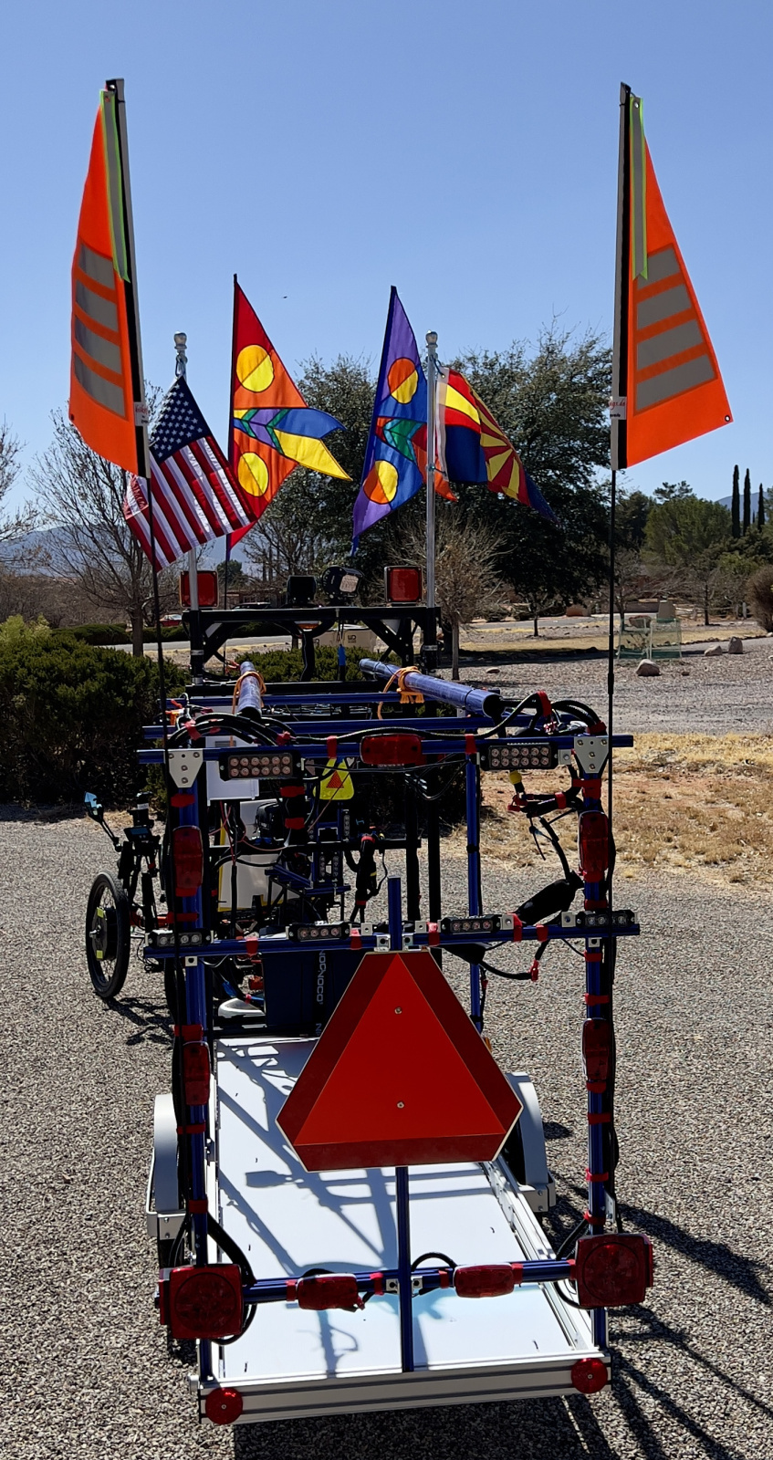 There are red running lights, turn signals, and flashers. There are two big red flashers, two small red flashers, and two small blue flashers. Modes are controlled by push bottoms noticeable on the right side. Note turn signals up high on the front of the trailer.