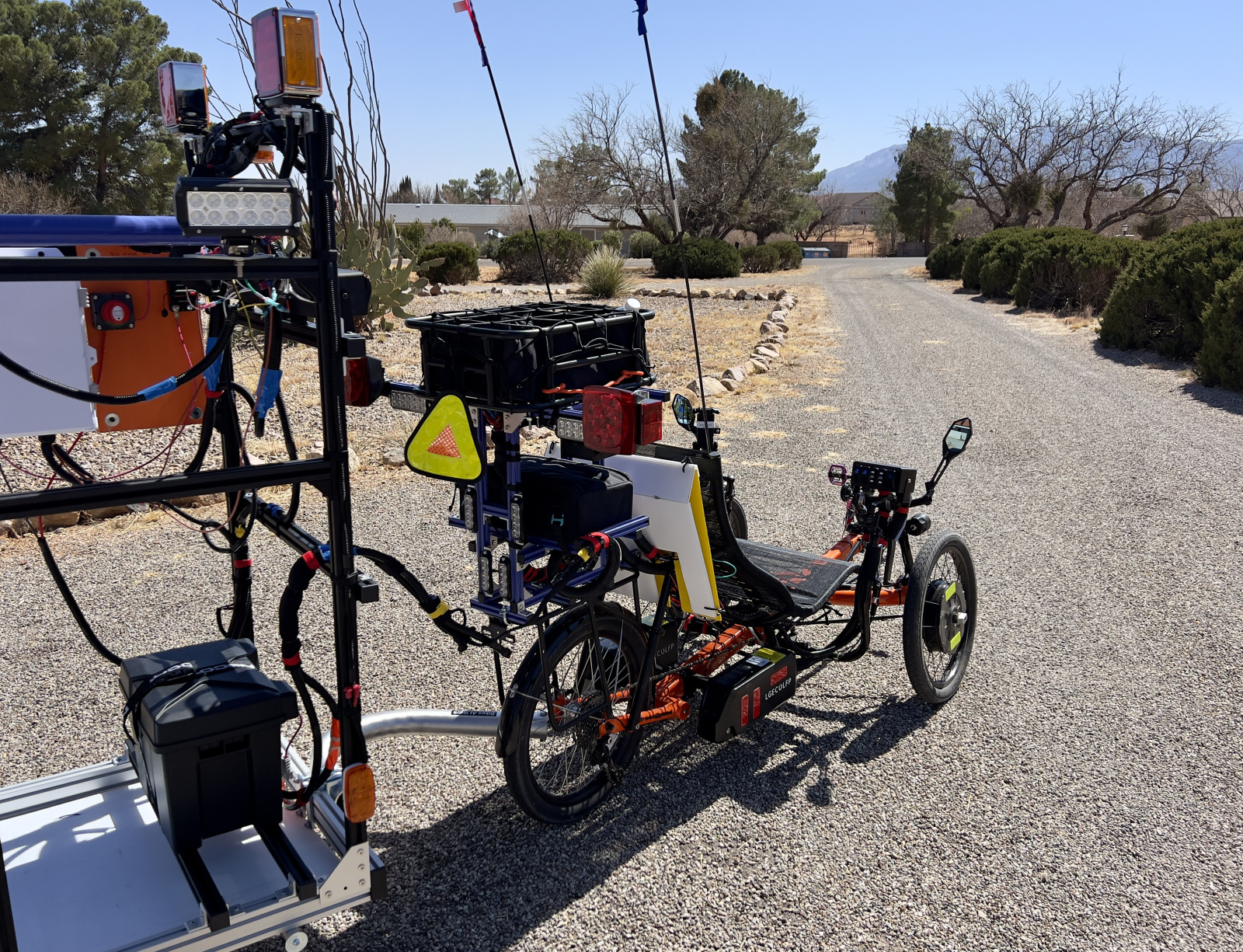 Note the turning signals and flashing lights. Rocker switches control which flashers are blinking. Switch on front of trike powers these switches. Panniers (not attached) hold a second set of batteries.