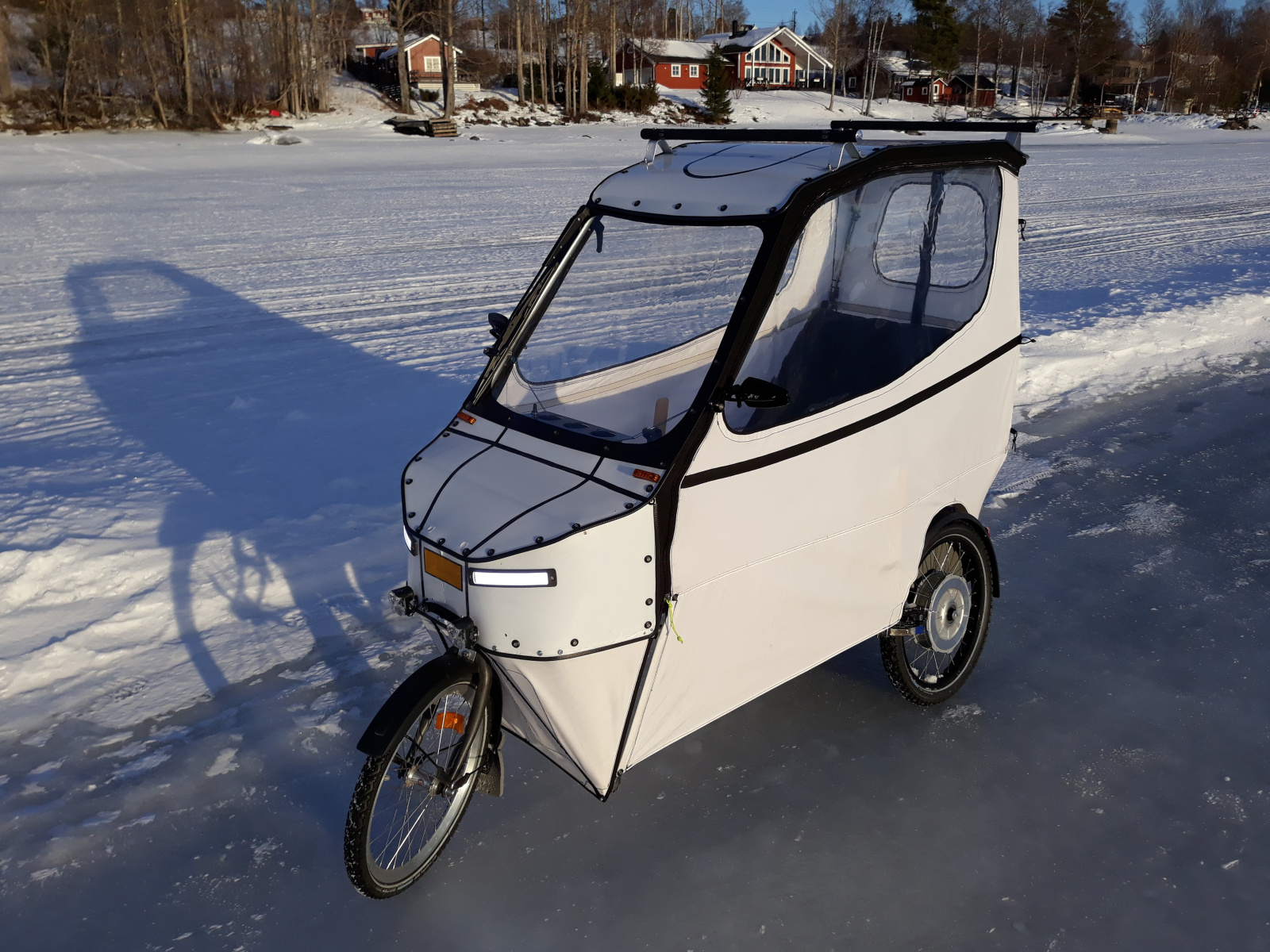 Lillen with closed sides on a plowed ice track on the lake.