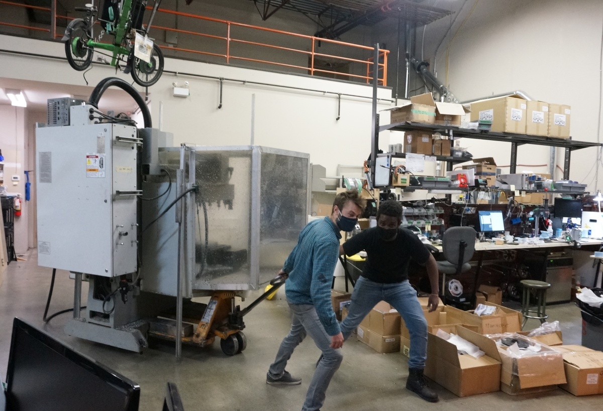 Robbie and Gabriel make short work of of bringing the CNC mill to the front of the shop.